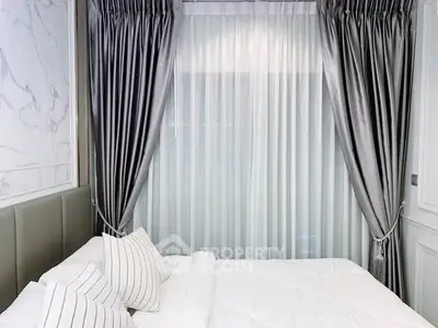 Luxurious bedroom with elegant curtains and plush bedding