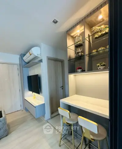 Modern living room with stylish bar counter and built-in shelving, perfect for urban living.