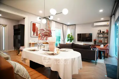 Modern living room with stylish decor, open layout, and elegant dining area.