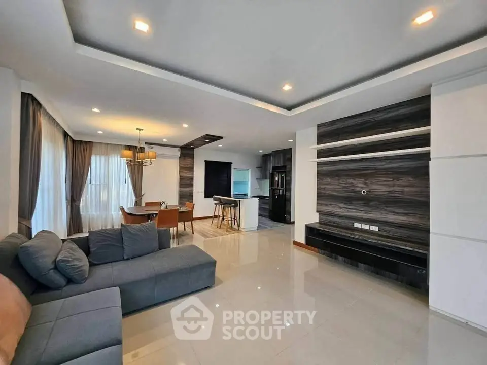Spacious modern living room with open kitchen and elegant dining area