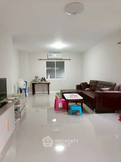 Spacious living room with modern furniture and glossy tiled flooring