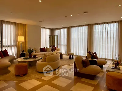 Luxurious living room with elegant furniture and floor-to-ceiling windows in a modern apartment.