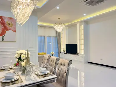 Luxurious modern living room with elegant dining area, chandeliers, and stylish decor