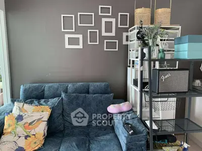 Cozy living room with blue sofa and decorative wall frames