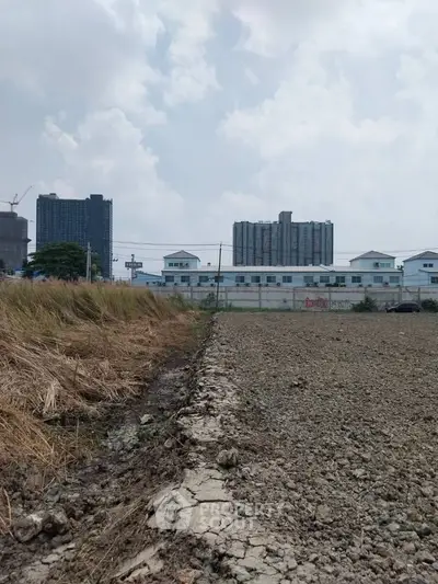 Vacant land with urban skyline, ideal for development opportunities.