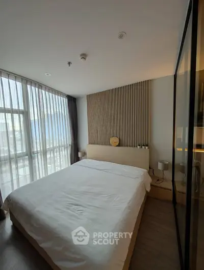 Modern bedroom with large window and stylish decor