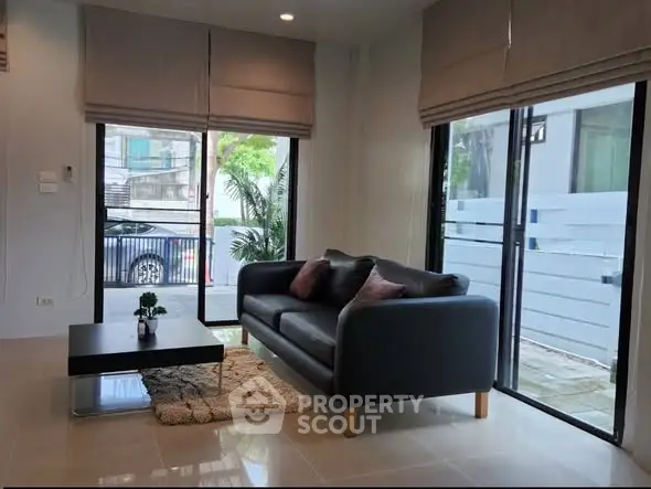 Modern living room with large windows and stylish furniture