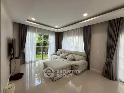 Spacious living room with modern decor and large windows for natural light