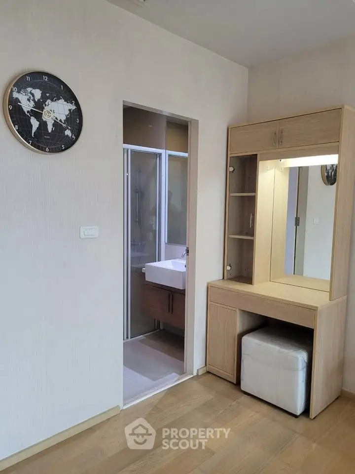 Modern bedroom with vanity and ensuite bathroom in stylish apartment