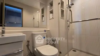 Modern bathroom with sleek fixtures and glass shower enclosure
