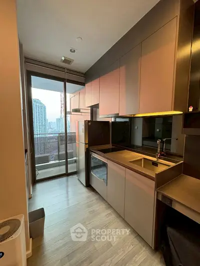 Modern kitchen with sleek cabinets and city view balcony