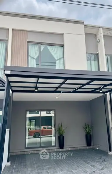 Modern townhouse exterior with covered parking and stylish facade