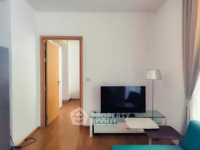 Modern living room with sleek TV setup and stylish lamp