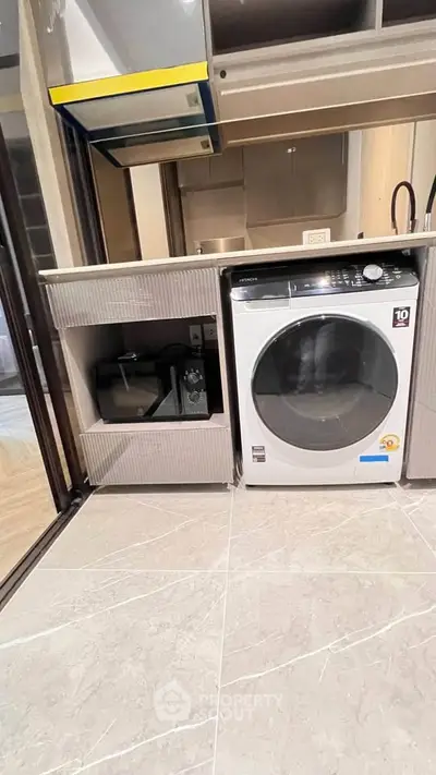 Modern kitchen with built-in washing machine and sleek cabinetry