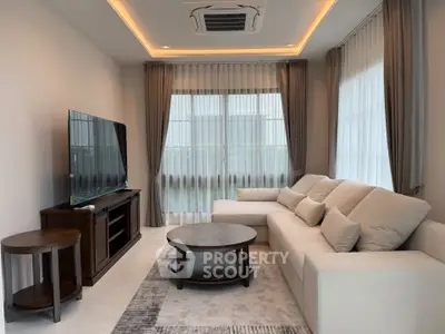 Elegant living room with modern furniture and large windows
