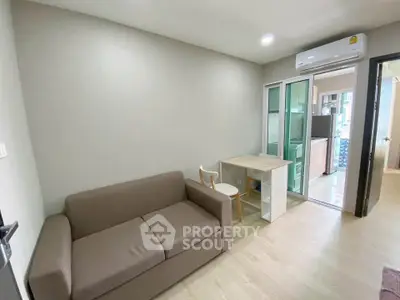 Modern compact living room with sofa and air conditioning in stylish apartment