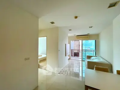 Spacious modern living room with balcony and city view in a high-rise apartment.