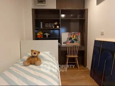 Cozy bedroom with study area and plush teddy bear on bed