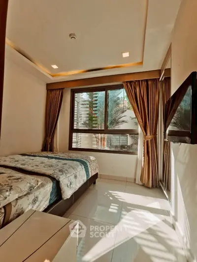 Elegant bedroom with large window and modern decor