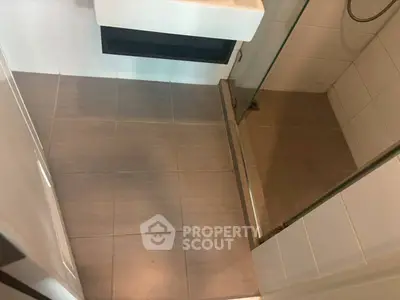 Modern bathroom with sleek tiles and glass shower enclosure