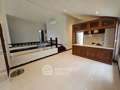 Spacious open-layout kitchen with wooden cabinets and modern design