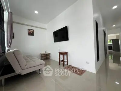 Modern living room with sleek design and wall-mounted TV