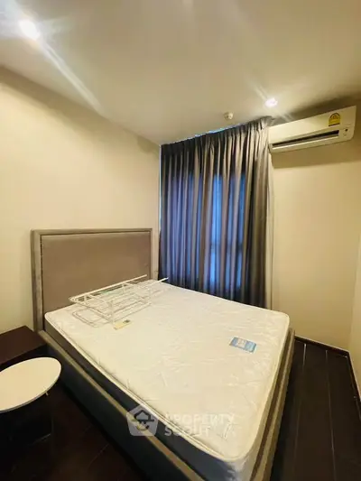 Cozy bedroom with modern air conditioning and elegant curtains, perfect for restful nights.