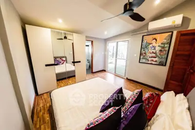Spacious bedroom with modern decor and large mirrored wardrobe