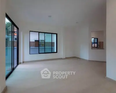 Spacious empty living room with large windows and modern design