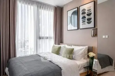 Modern bedroom with stylish decor and large window for natural light
