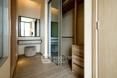 Luxurious walk-in closet with elegant wooden finishes and modern design.