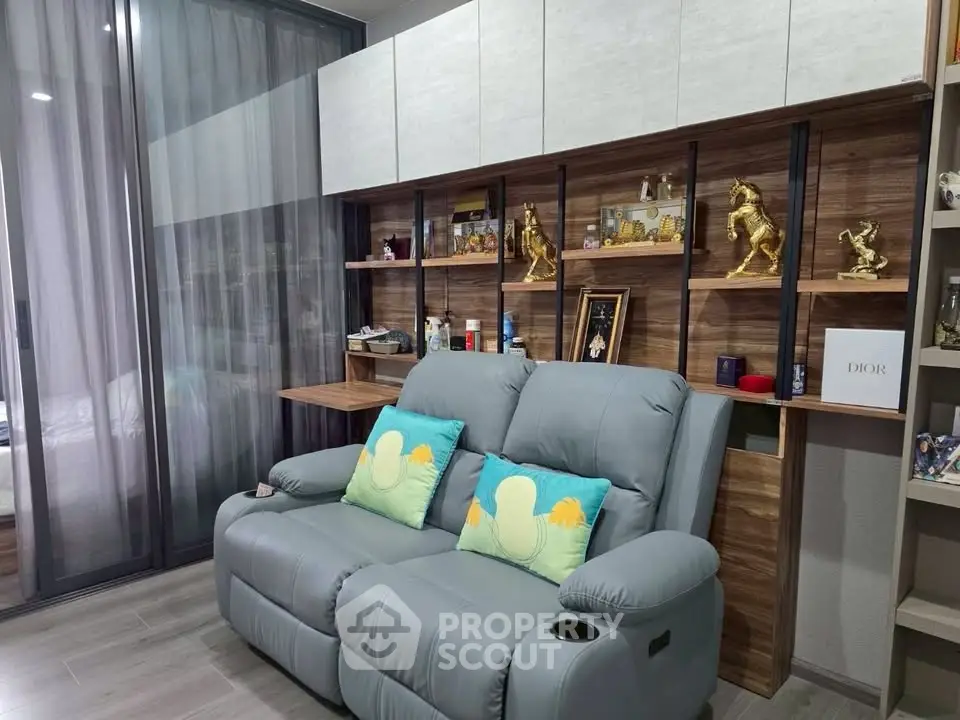 Modern living room with stylish shelving and cozy seating in a contemporary apartment.