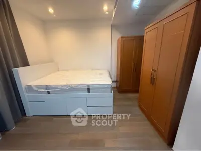 Modern bedroom with wooden wardrobe and sleek bed design