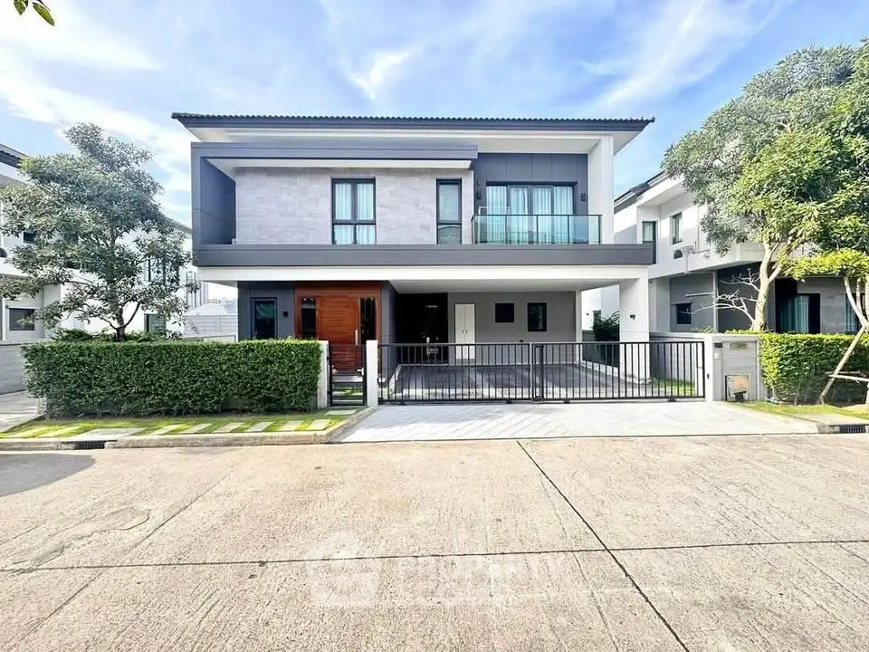 Modern two-story house with sleek design and spacious driveway in a serene neighborhood.