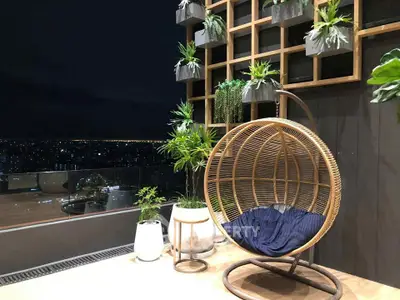 Stunning balcony with city view and stylish hanging chair, perfect for relaxation.