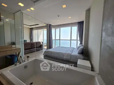 Luxurious bedroom with ocean view and modern bathtub in high-rise apartment