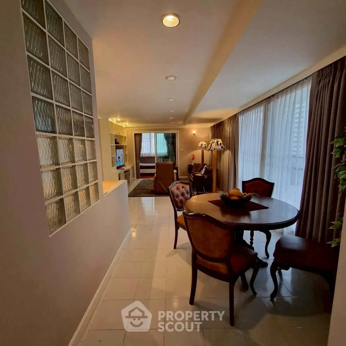 Charming dining area with elegant furniture and natural light in a cozy apartment setting.