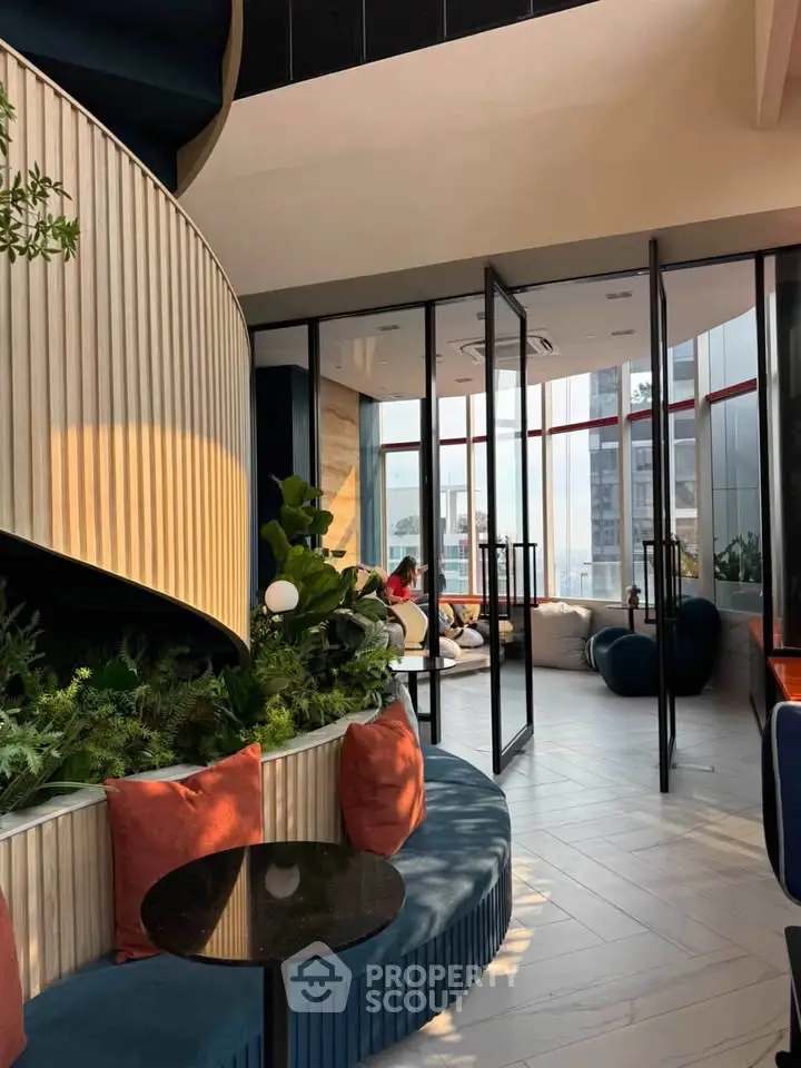 Luxurious modern interior with floor-to-ceiling windows and stylish seating area, perfect for relaxation.