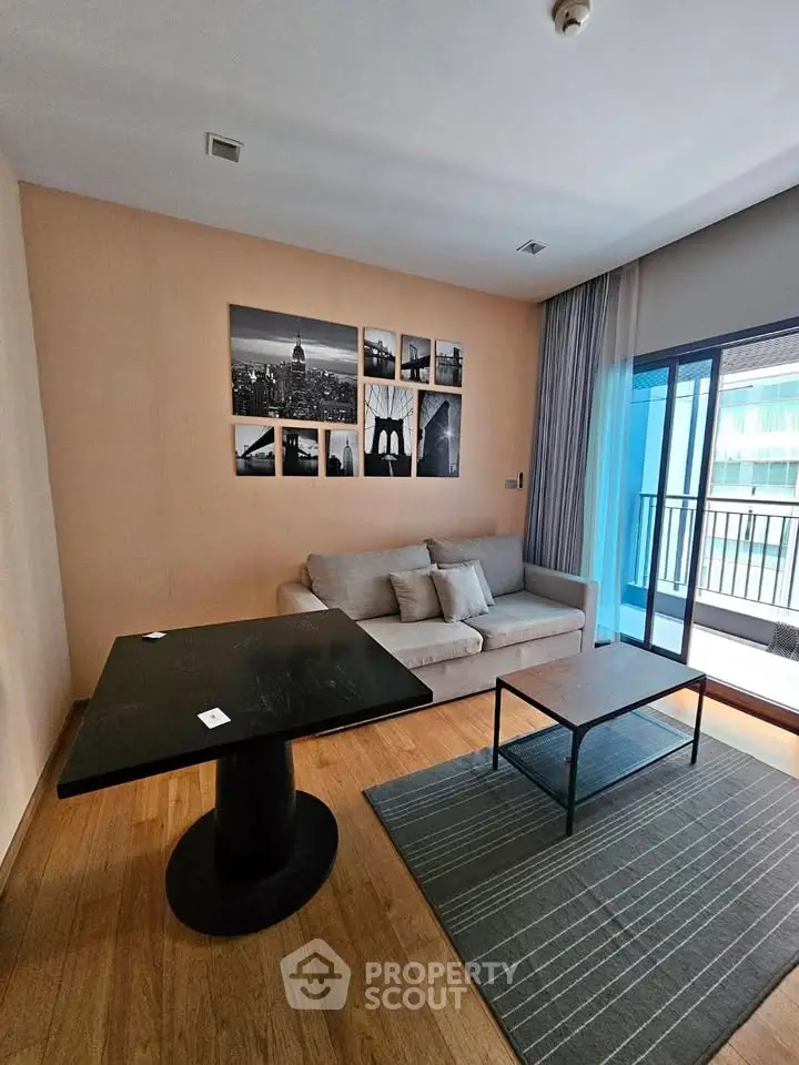 Modern living room with stylish decor and balcony access in urban apartment