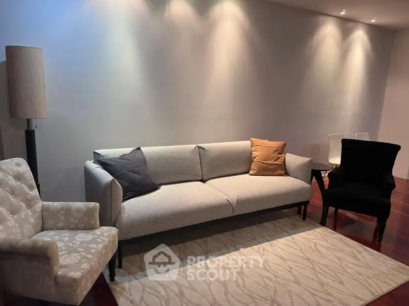 Stylish living room with modern sofa and elegant lighting, perfect for cozy evenings.