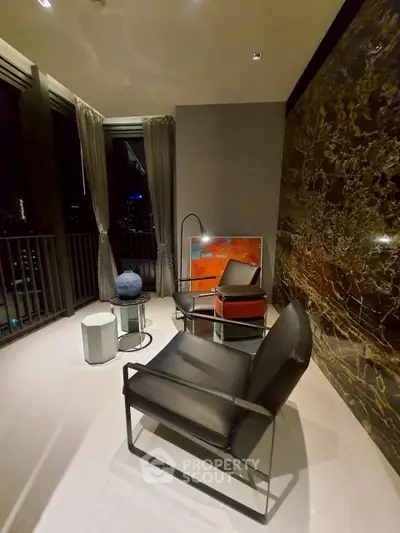 Luxurious modern living room with elegant black chairs and stunning city view at night.