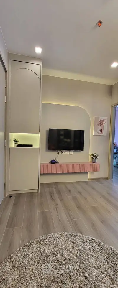 Modern living room with stylish TV setup and elegant lighting
