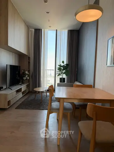 Modern living room with stylish furniture and large windows offering natural light.