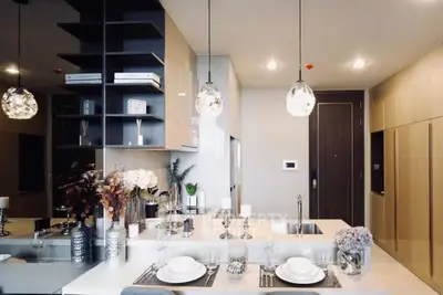 Luxurious modern kitchen with elegant decor and open layout, featuring stylish pendant lighting and sleek cabinetry.