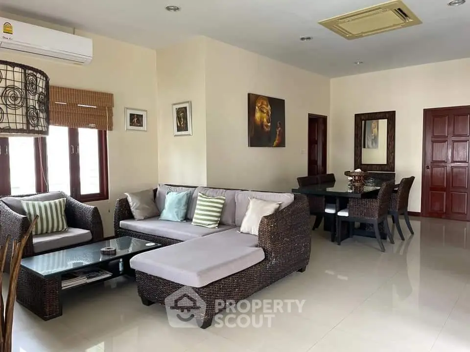 Spacious living room with modern furniture and elegant dining area in open layout.