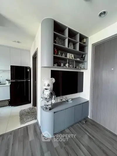 Modern living room with sleek TV unit and open kitchen view