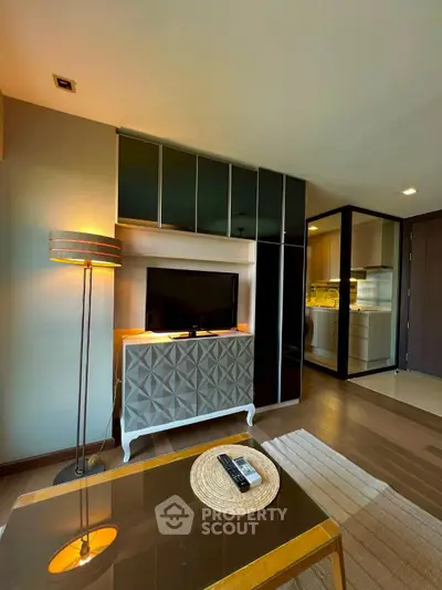 Modern living room with stylish decor and open kitchen layout.