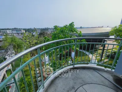 Stunning balcony view overlooking lush greenery and cityscape