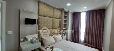 Elegant bedroom with stylish decor and natural light, featuring a cozy bed and modern shelving.