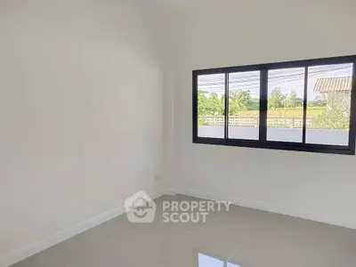 Bright empty room with large window and glossy tiled floor, perfect for customization.